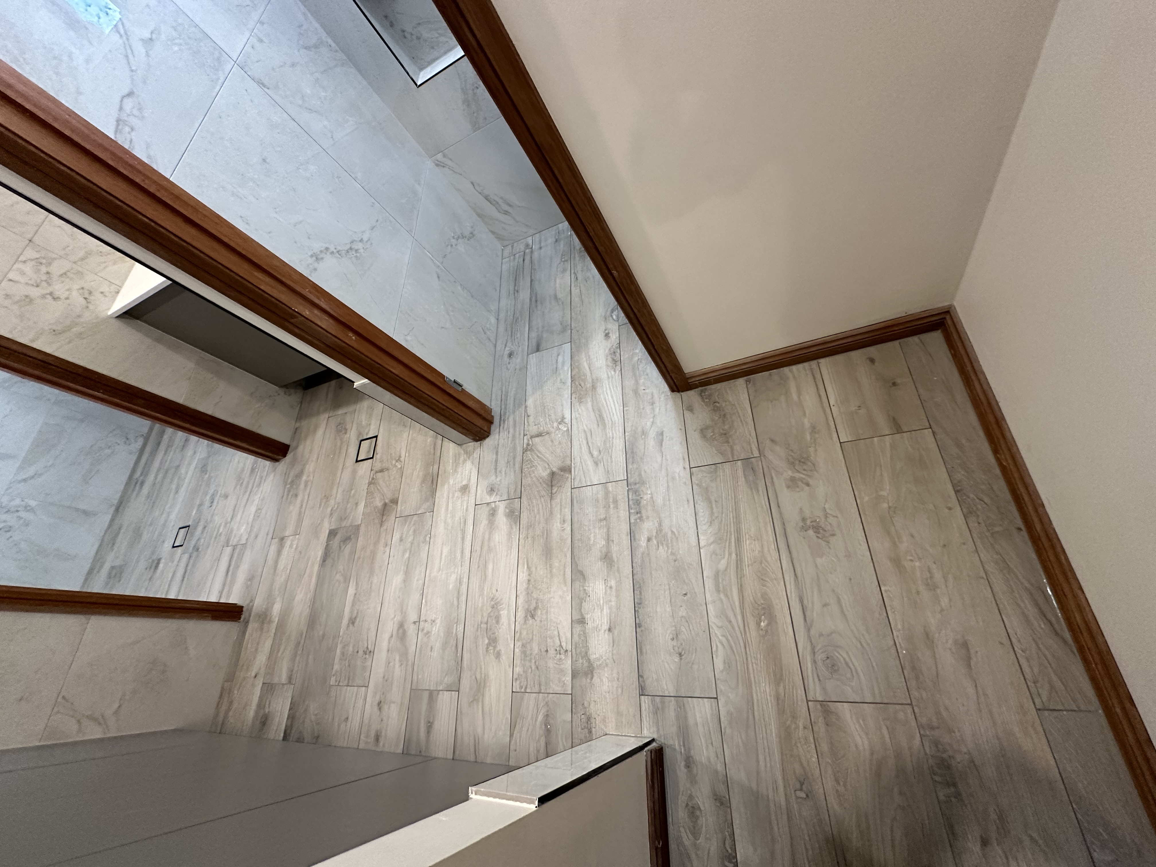 Professionally installed timber-look floor tiles with clean grout lines