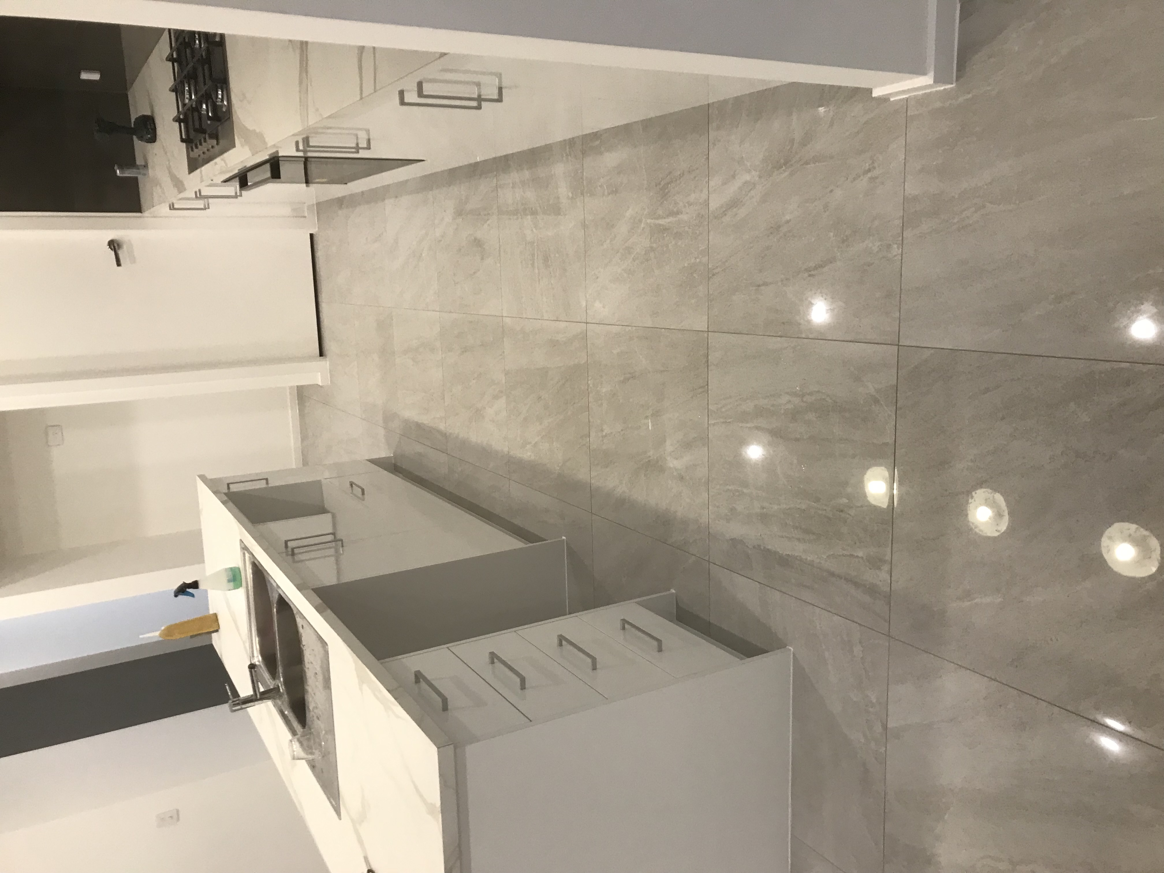 Professionally tiled kitchen splashback and floor with clean grout lines