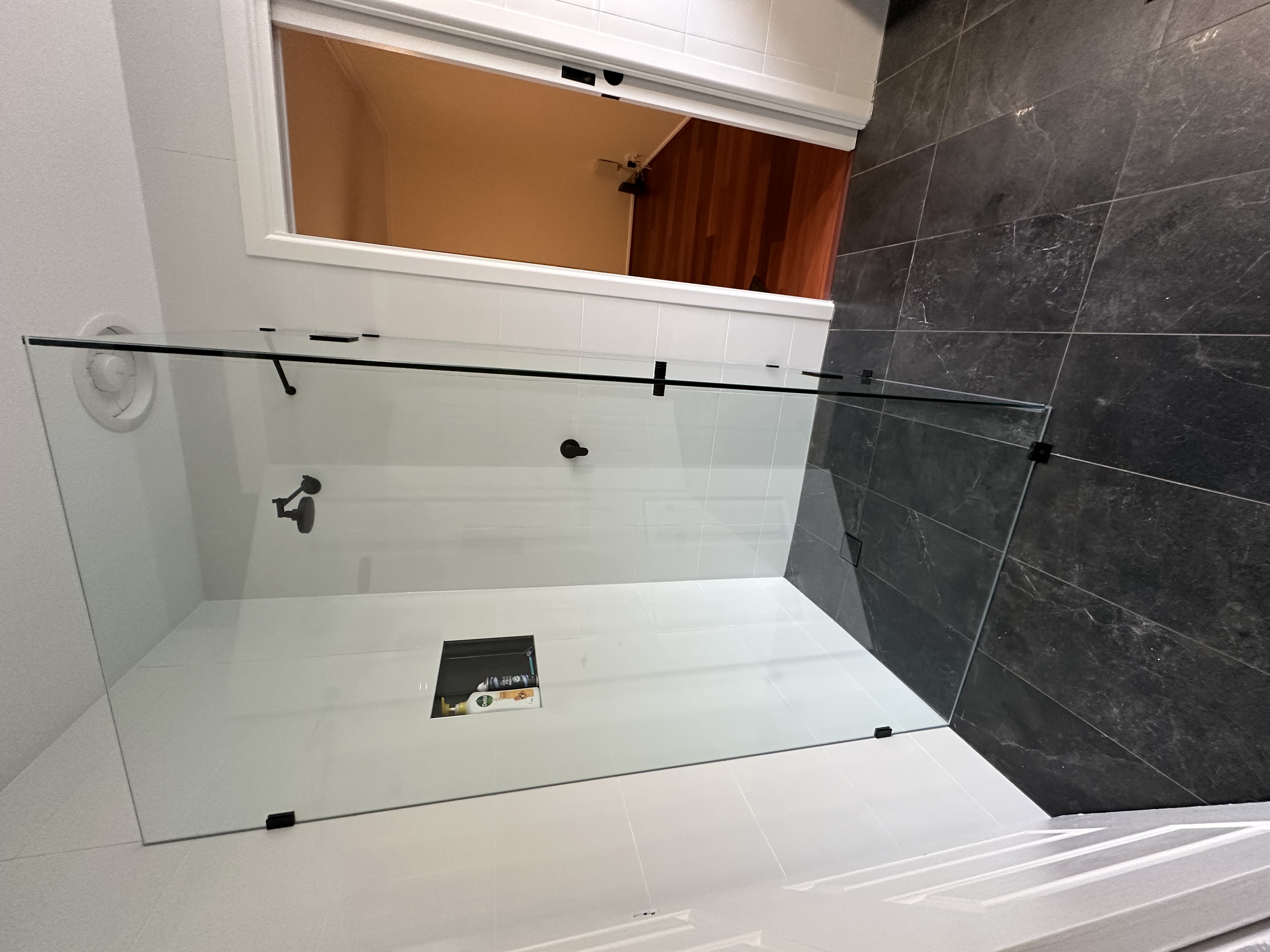 Modern tiled bathroom with toilet and clean wall and floor finishes