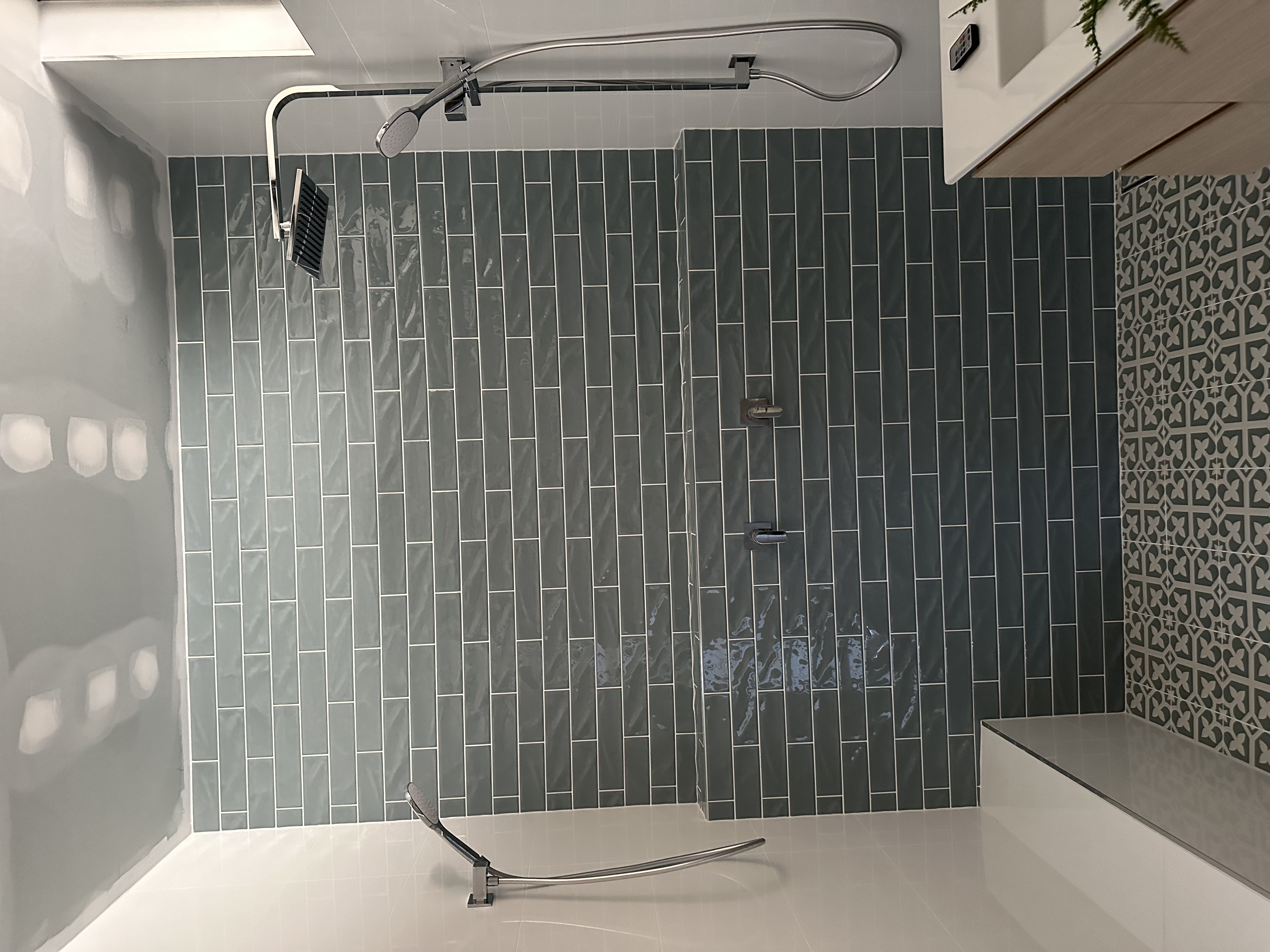 Patterned bathroom floor tiles installed with precise spacing